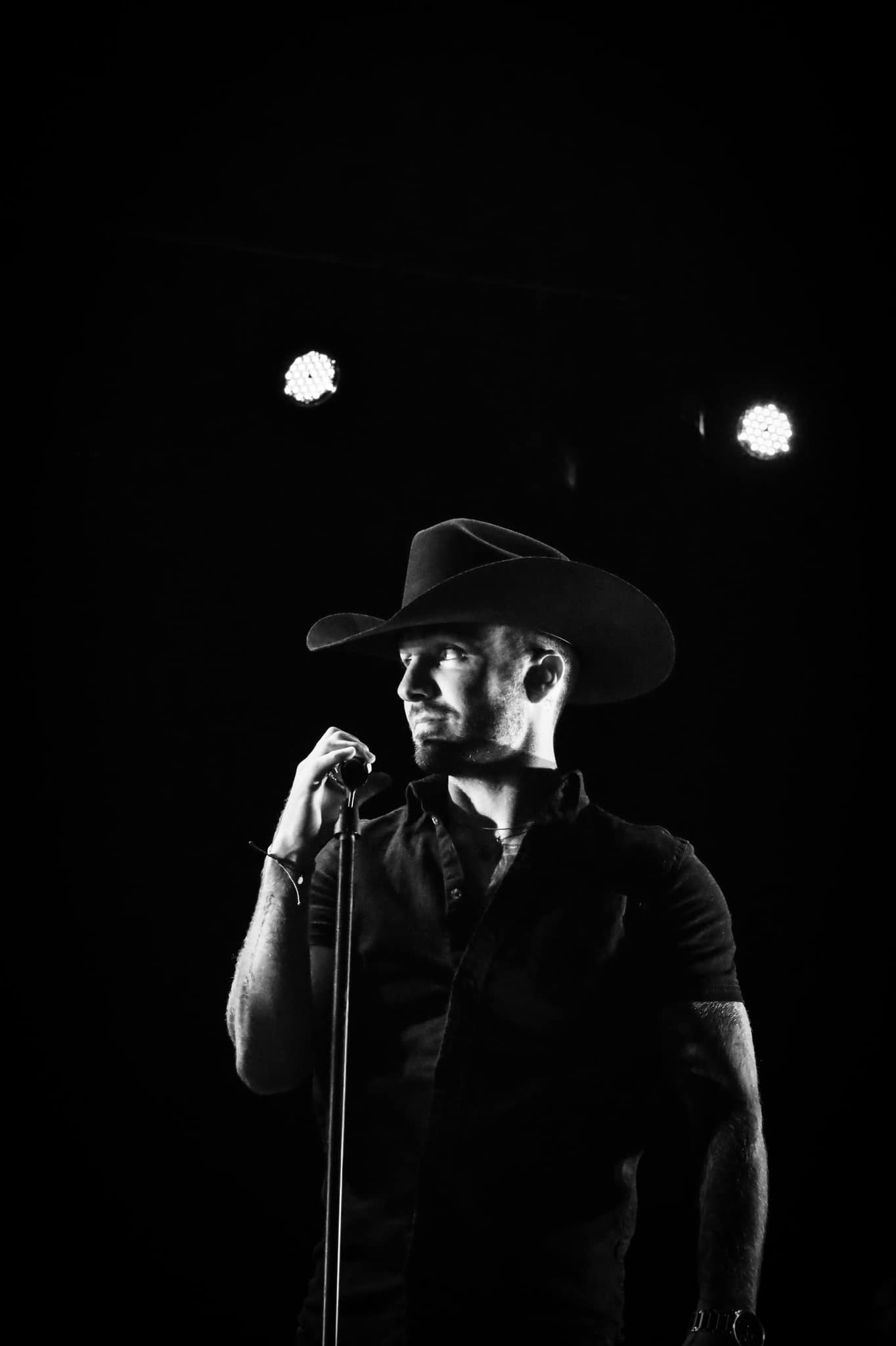 Cody with cowboy hat on stage